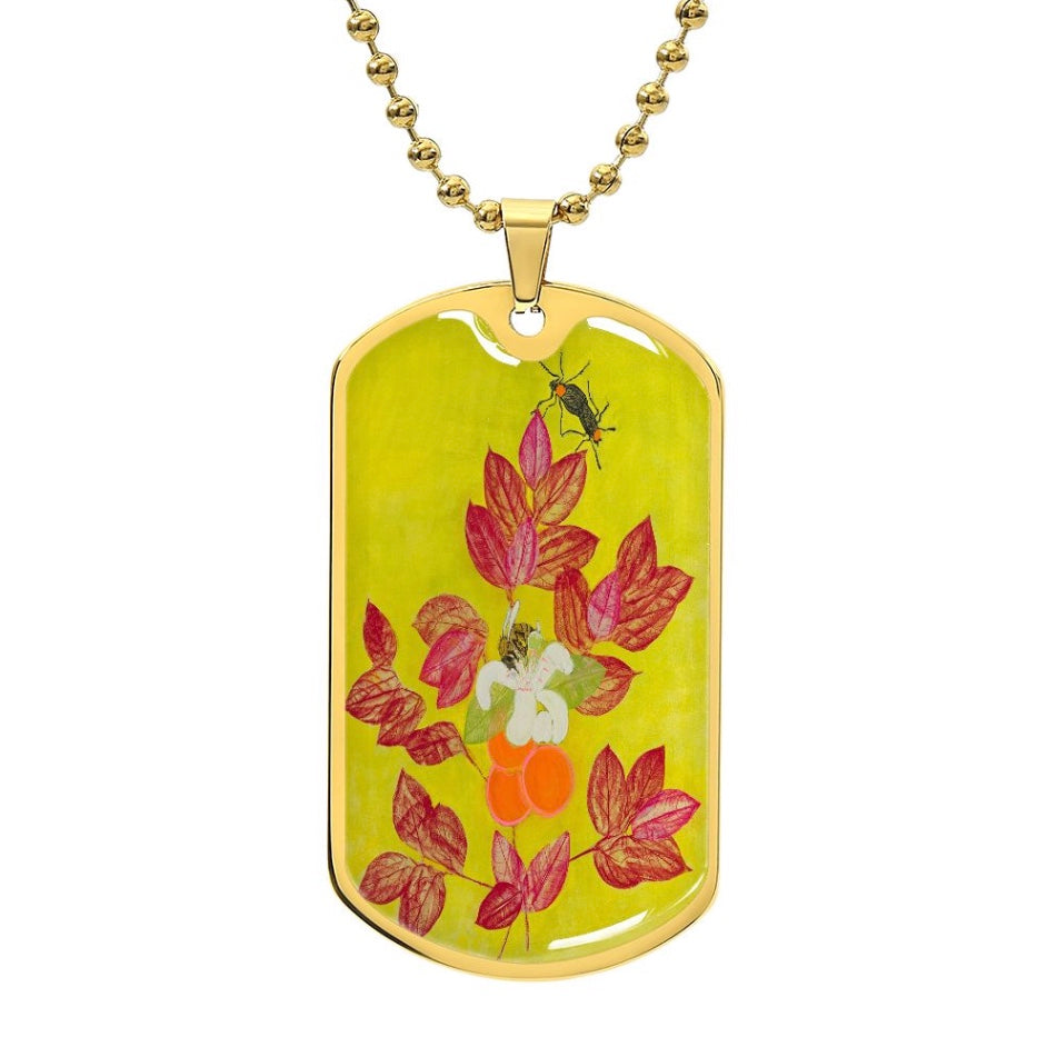 Dog tag style necklace with yellow design that has pink leaves, oranges, bees and lovebugs