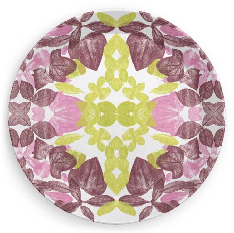 a plate with a leaf design in pink, wine and chartreuse colors