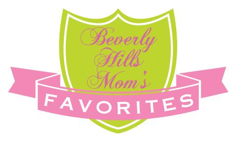 A green shield with a pink sash with letters saying Beverly Hills Mom's favorites